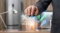Businessman hand touching holographic house icon with percentage symbol and growth arrows representing real estate investment returns and property value increase.