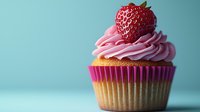 Fresh strawberry cupcake with pink buttercream frosting and whole berry on top against turquoise background, studio food photography for bakery marketing.