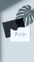 Thank you card with black envelope on white background, monstera leaf shadow, elegant minimal style for greeting, wedding, or event design.