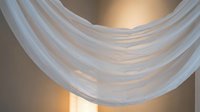 Abstract white curved lines creating flowing wave patterns with warm golden lighting effects for modern design backgrounds.
