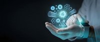 Business professional holding glowing digital gears and cogs representing innovation, technology solutions, and industrial automation concepts.