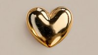 Golden metallic heart shape isolated on beige background for romantic designs, Valentine's Day decorations, love symbols, wedding invitations and luxury branding.