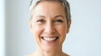 Mature woman with short gray hair and warm smile, radiating confidence and positivity. Ideal for healthcare, wellness, corporate, and lifestyle marketing materials.