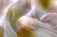 Soft pink and gold polka dot pattern on white silk fabric creates elegant abstract background with gentle folds and luxurious texture for feminine designs.