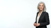 Mature woman with gray hair wearing black blazer and white shirt, smiling at camera against white background for corporate portraits.