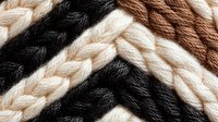 Colorful twisted rope strands in brown, black and beige creating textured pattern for nautical, craft and industrial design projects.
