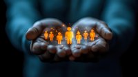 Business professional cupping hands protecting glowing orange human figures representing team care, leadership, employee protection and corporate responsibility.
