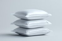 Stack of three white soft pillows on light background, minimalist composition showing texture and comfort for bedroom and home decor designs.