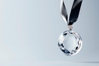 Crystal glass ball pendant with black ribbon hanging against light background, elegant minimalist jewelry design showcasing faceted transparent gemstone detail.