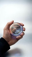 Hand holding glowing circular badge with integration completion text and puzzle piece circuit design for business achievement and technology success.