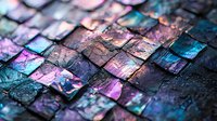 Iridescent mosaic tiles with purple and turquoise reflections create abstract pattern. Dark grout between metallic squares adds depth and texture. Artistic background.