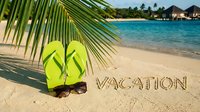 Bright green flip flops and sunglasses on sandy tropical beach with vacation written in sand, palm leaf, turquoise ocean, summer holiday concept.