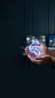 Hands holding glowing digital energy with sparkling light effects against dark background for technology and innovation concepts.