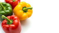 Fresh colorful bell peppers red yellow green isolated on white background for healthy cooking recipes and organic vegetable nutrition concepts.