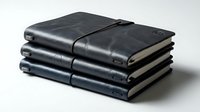 Stack of dark navy blue leather journals with elastic closure bands, stacked on white background for business and travel use.