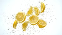 Fresh lemon slices flying through the air with dynamic water splashes on a white background, capturing vibrant citrus energy.