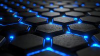 Hexagonal black textured pattern with glowing blue light between segments creates futuristic technological background with dramatic depth and shadow effect.