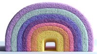 Colorful foam rainbow toy with textured surface in pastel purple, mint, blue, pink, orange, and yellow hues on white background.