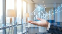 Businessman hand presenting financial growth chart with dollar symbols and upward arrows in modern office environment for investment presentations.