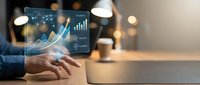 Businessman hand touching holographic display with rising financial charts and growth analytics on digital tablet for business strategy.