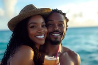 Happy African American couple enjoying tropical beach vacation together during golden hour sunset with ocean backdrop.