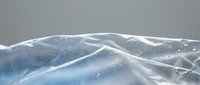 Abstract flowing white and blue fabric waves creating dynamic movement against gray background for modern design projects and creative presentations.