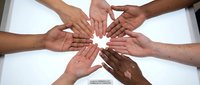 Diverse hands joining together in unity circle showing teamwork, collaboration and community support concept on white background.