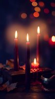 Burning candles create warm atmospheric lighting with colorful bokeh lights in background for cozy evening ambiance and relaxation mood.