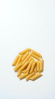 Pile of golden penne pasta isolated on white background, ready for food packaging, recipe blogs, restaurant menus, and culinary design projects.