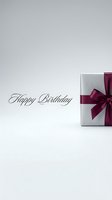 Happy Birthday greeting card with elegant silver gift box tied with burgundy ribbon bow on light gray background.