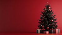 Decorated Christmas tree with glowing lights and wrapped presents underneath against deep red wall background creating festive holiday atmosphere.