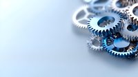 Metal gears and cogs with blue tint on light background, shallow depth of field macro shot showing mechanical parts and industrial engineering components.