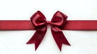 Elegant burgundy satin ribbon bow with flowing tails on white background, perfect for gift wrapping, holiday decorations and festive celebrations.