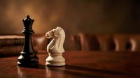 Chess pieces black queen and white knight on wooden board with warm lighting creating strategic game atmosphere for business concepts.