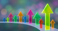 Colorful upward arrows on curved surface with vibrant bokeh background representing growth, success, progress and business development concepts.