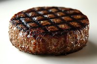 Grilled beef burger patty with diamond grill marks on white background, juicy cooked meat for barbecue restaurant menu and food photography.