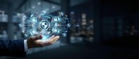 Businessman hand holding digital security shield with network icons and data protection symbols on blurred city background for cybersecurity and technology concepts.