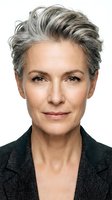 Mature woman with short gray hair and fair complexion wearing dark blazer, isolated on white background for corporate and professional use.