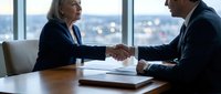 Two business professionals shaking hands across wooden desk in modern office with city skyline view, representing corporate agreement, partnership deal, and successful negotiation.