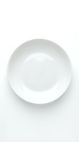 Empty white ceramic bowl isolated on white background, ready for food styling, restaurant menus, cooking blogs, and culinary design projects.