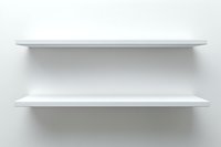 Empty white shelves mounted on light gray wall, casting subtle shadows. Clean minimal design for product display and interior decoration purposes.
