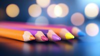 Colorful wooden pencils arranged in row with soft bokeh background creating artistic composition with selective focus and vibrant colors.