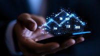 Digital smart home concept with glowing blue house hologram emerging from smartphone in hands against dark background, illustrating modern property technology solutions.