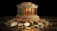 Golden classical bank building with columns surrounded by scattered coins on wooden surface against dark background for financial concepts.