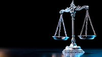 Ornate silver scales of justice on dark background with dramatic blue lighting, symbolizing law, judgment, and legal balance in professional settings.