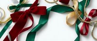 Festive Christmas ribbons in red, green and gold colors arranged on white background creating decorative border frame for holiday greeting cards and gift wrapping.