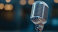 Vintage style microphone on blurred bokeh background with dramatic lighting and copy space. Professional audio equipment for broadcasting and music recording.