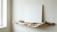 Natural driftwood branch with rope detail mounted on white wall near window, rustic coastal home decor element for modern minimalist interior design.