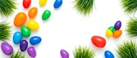 Colorful Easter eggs scattered on white background with fresh green grass border frame for spring holiday celebration and festive decoration design.
