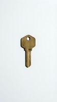 Vintage brass key isolated on white background, ready for design use in security, access, and lock-related projects.
